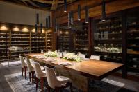 a dining room with a long wooden table and chairs at Chablé Maroma in Playa del Carmen