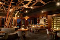 a restaurant with tables and chairs and a bar at Chablé Maroma in Playa del Carmen