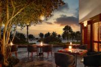 a restaurant with two tables and chairs and a sunset at Chablé Maroma in Playa del Carmen