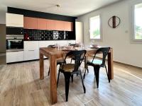 a kitchen with a wooden table and two chairs at Le Saint-Jalmes P2 + Parking in Nîmes