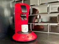 a red coffee maker with a cup on a counter at Le Saint-Jalmes P2 + Parking in Nîmes