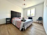 a bedroom with a bed and a chair in it at Le Saint-Jalmes P2 + Parking in Nîmes