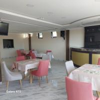 a dining room with tables and red chairs at Hostal Kapital II in Quito
