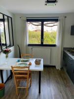 a kitchen with a table and two chairs and a table and a window at Appartement indépendant 30 m² à 500m du lac, 2 vélos et parking fournis in Sévrier