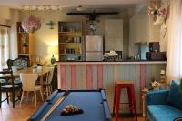 a living room with a pool table and a kitchen at Star Wish B&amp;B in Dongshan