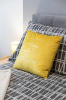 a yellow pillow sitting on top of a bed at Lux oasis with private parking in Zagreb