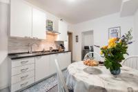 a kitchen with a table with a vase of flowers on it at Apartment Ivana in Roč