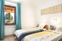 a bedroom with two beds and a window at Apartment Ivana in Roč