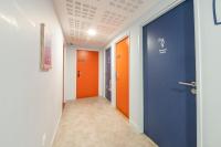 a hallway with orange and blue doors at UCPA SPORT STATION HOSTEL PARIS in Paris