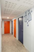an empty hallway with four different colored doors at UCPA SPORT STATION HOSTEL PARIS in Paris