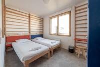 a room with two beds and a desk in it at UCPA SPORT STATION HOSTEL PARIS in Paris