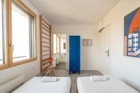 two beds in a small room with a window at UCPA SPORT STATION HOSTEL PARIS in Paris