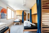 a bedroom with a bunk bed and a bunk room with a ladder at UCPA SPORT STATION HOSTEL PARIS in Paris