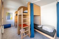 a room with bunk beds and a dining room at UCPA SPORT STATION HOSTEL PARIS in Paris