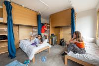 a group of people sitting on beds in a room at UCPA SPORT STATION HOSTEL PARIS in Paris