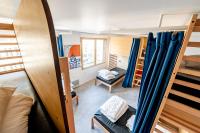 a room with several bunk beds and a room with at UCPA SPORT STATION HOSTEL PARIS in Paris