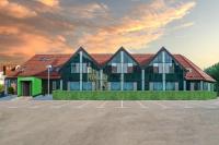 a building with a parking lot in front of it at SEKRA Stadthotel in Heidenheim
