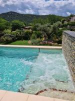 a swimming pool with blue water in a yard at Gîte spa la parenthèse in Sauve