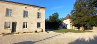 a large stone house with a driveway in front of it at Suite privée indépendant dans ancien pigeonniet in Pouilly-sur-Vingeanne