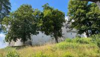 a building sitting on top of a hill with trees at L&#39;Escapade de Pierrefonds par Your Sweet Loc in Pierrefonds