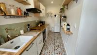 a small kitchen with a sink and a counter at L&#39;Escapade de Pierrefonds par Your Sweet Loc in Pierrefonds