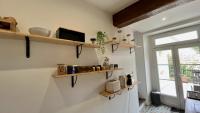 a kitchen with wooden shelves on the wall at L&#39;Escapade de Pierrefonds par Your Sweet Loc in Pierrefonds