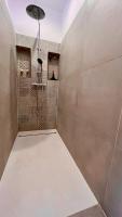 a bathroom with a shower with a shower head at L&#39;Escapade de Pierrefonds par Your Sweet Loc in Pierrefonds