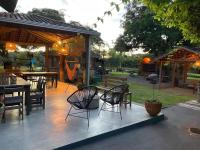 un patio con alcune sedie e tavoli e un tavolo di Jardim da Amazônia Lodge a Sao Jose do Rio Claro