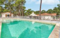 a swimming pool with blue water in a house at 2 Bedroom Beautiful Home In La Faute-sur-mer in La Faute-sur-Mer