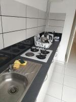 a kitchen counter with a stove and a sink at Joli appartement proche métro in Lyon