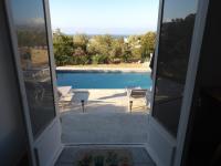 a view of a pool from the door of a house at Villa de standing in Calvi