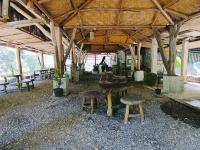 a group of tables and benches in a pavilion at Back to Nature Ecotourism in Bukit Lawang