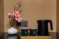Guangzhou Wogo Yuanbao Hotel-Zhujiang New Town-Free Canton Fair Shuttle Bus & Overseas Buyer Registration Servicesにあるコーヒーまたはお茶