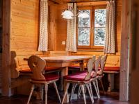 a dining room with a wooden table and chairs at Alpin-Hütten auf der Turracherhöhe Haus Murmeltier by S4Y in Turracher Hohe