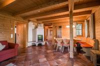 a living room of a log cabin with a table and chairs at Alpin-Hütten auf der Turracherhöhe Haus Murmeltier by S4Y in Turracher Hohe