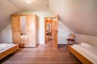 a attic room with two beds and a mirror at Alpin-Hütten auf der Turracherhöhe Haus Murmeltier by S4Y in Turracher Hohe