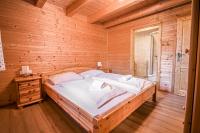 a bedroom with a large bed in a wooden room at Alpin-Hütten auf der Turracherhöhe Haus Murmeltier by S4Y in Turracher Hohe