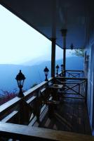 a porch of a house with a view of the mountains at Emmanuel Farm House in Ren&#39;ai