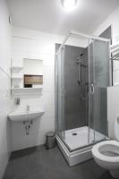 a bathroom with a shower and a sink and a toilet at F Hotel in Hörsching