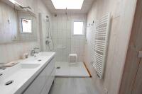 a white bathroom with a sink and a shower at Le VISCOS à AGOS-VIDALOS in Agos-Vidalos