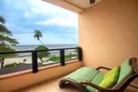 a balcony with a couch and a view of the beach at DoubleTree by Hilton Seychelles Allamanda Resort & Spa in Takamaka
