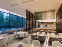 an image of a restaurant with tables and chairs at Doubletree By Hilton Kunming Airport in Kunming