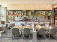 a restaurant with tables and chairs in a room at Doubletree By Hilton Kunming Airport in Kunming