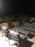 a patio with two chairs and a table and a couch at Penthouse 120 m2 vue imprenable Lattes in Lattes