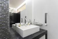 a white bathroom with a large white sink at Luxury modern two bedroom duplex by Roland Garros in Paris