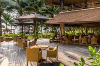 a restaurant with tables and chairs and umbrellas at High Season Pool Villa & Spa in Ko Kood