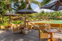 a restaurant with tables and chairs and a pool at High Season Pool Villa & Spa in Ko Kood