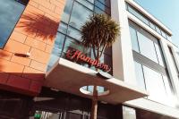 a sign on the side of a building with a palm tree at Hampton By Hilton Torquay in Torquay