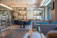 a restaurant with chairs and a table in a room at IXORA Hotel & Spa Snowdonia in Conwy