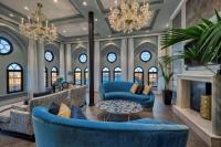 a living room with blue furniture and a fireplace at Hilton Molino Stucky Venice in Venice